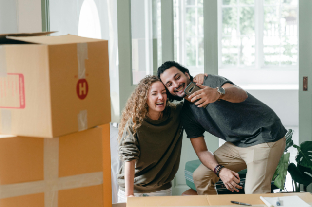couple smiling new home unpacking