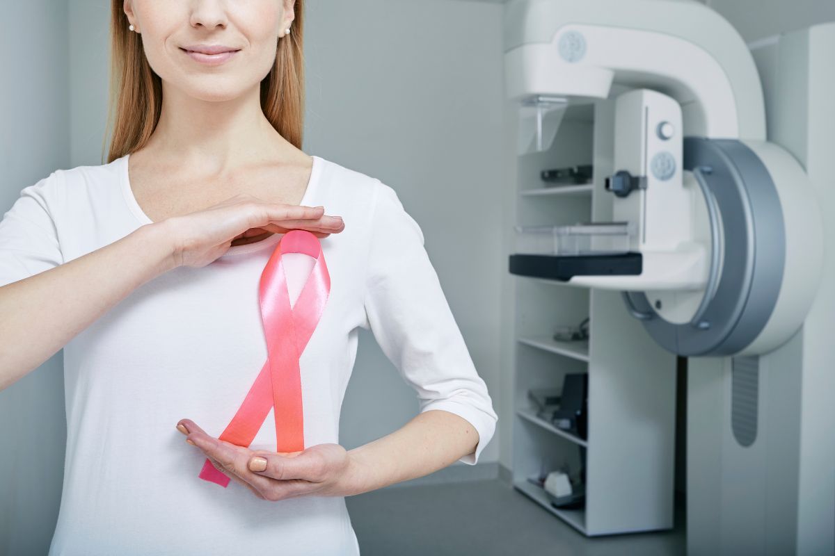 woman holding breast cancer symbol