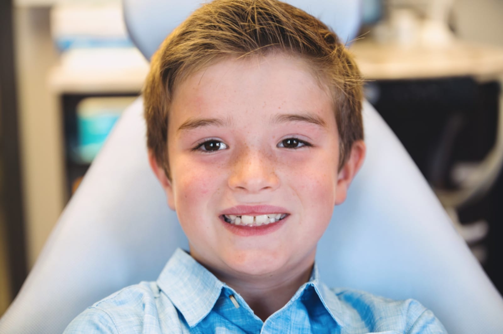 Young boy smiling in the dental exam chair at pediatric dental office