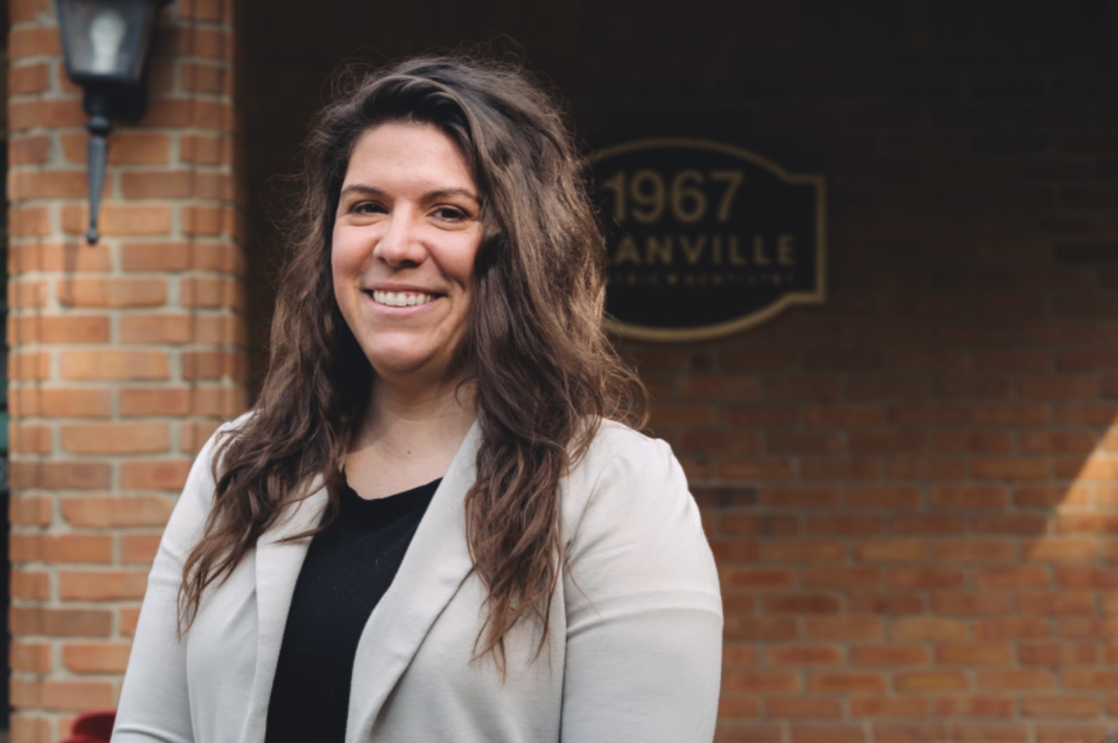 Smiling female team member at Granville Pediatric Dentistry reception desk area