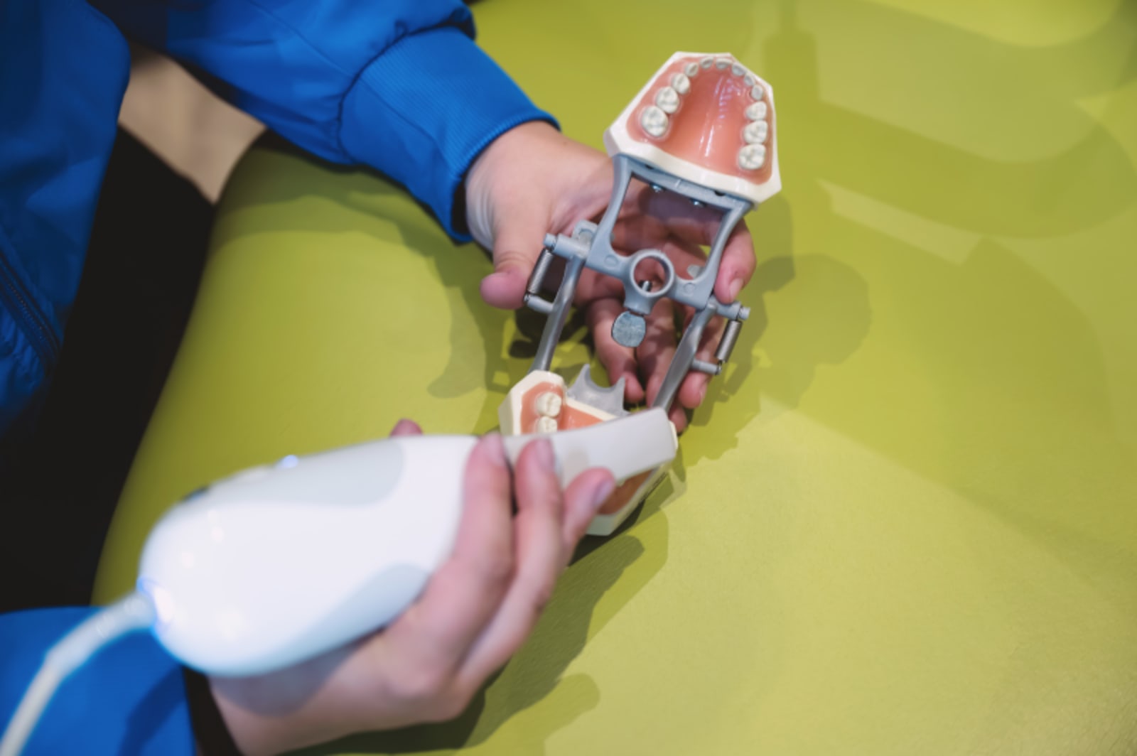 Dentist demonstrating dental tools and model showing how nitrous oxide works