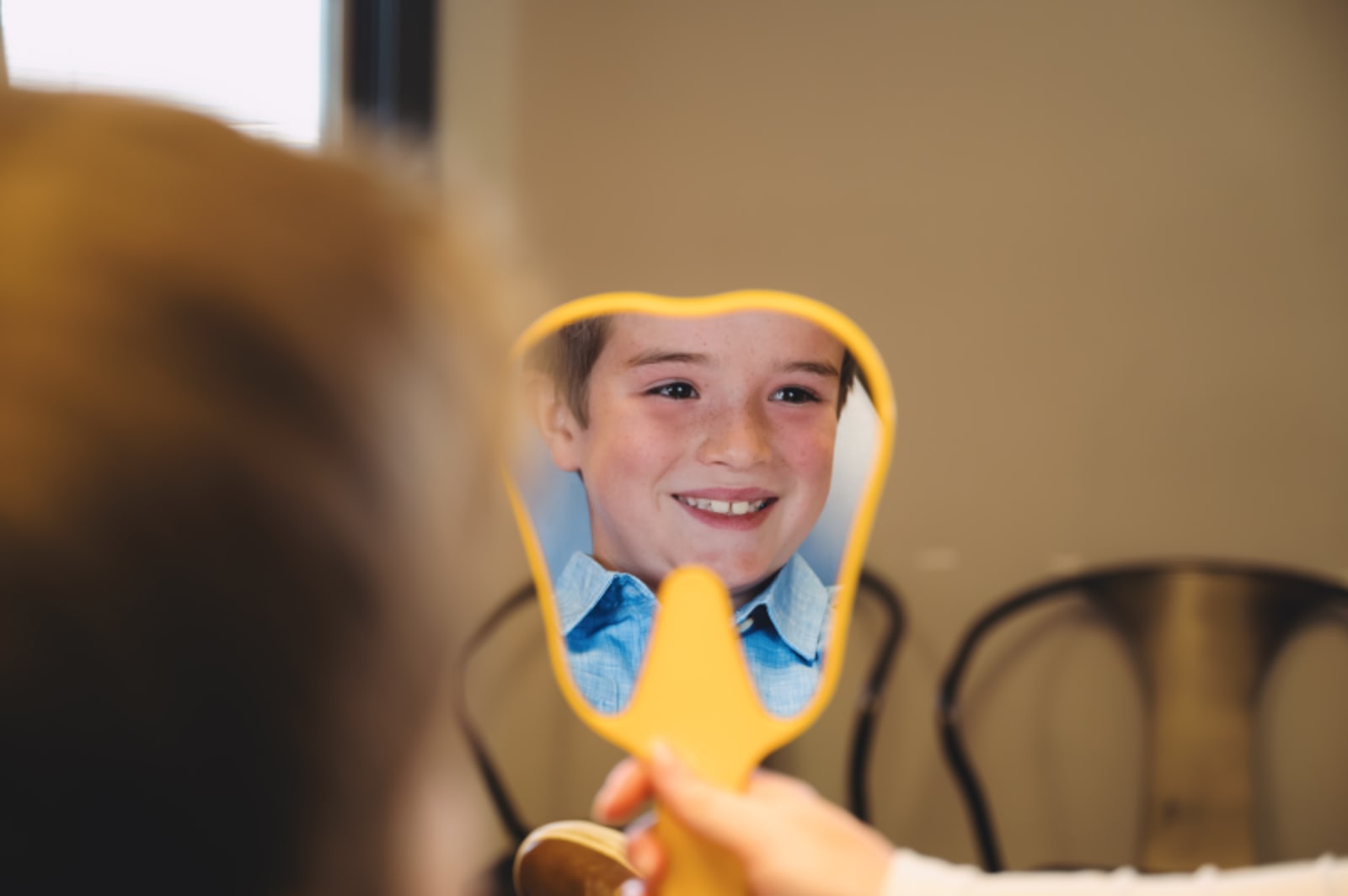 Young child smiling during a dental examination.