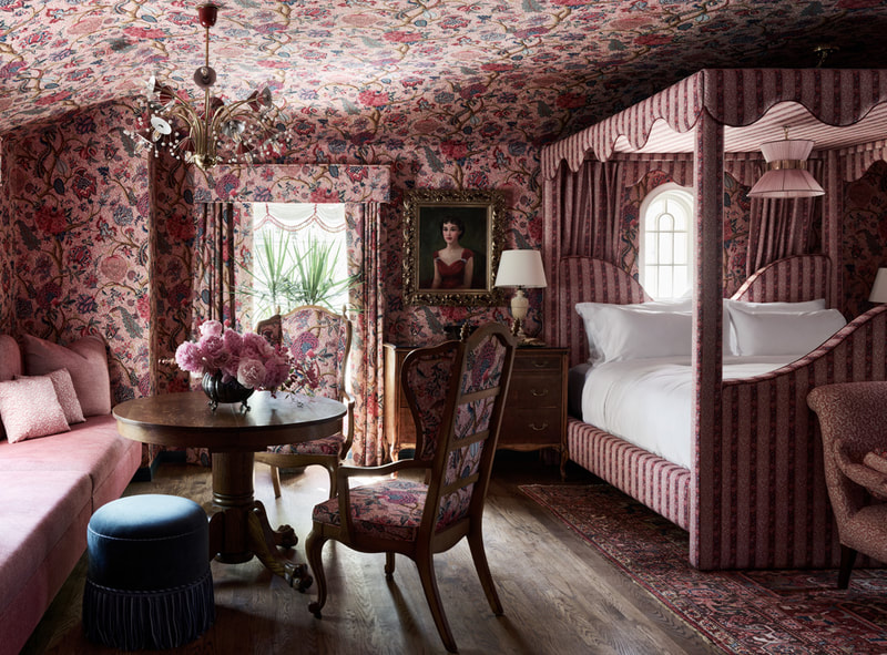 This sitting area in a rosy bedroom makes for a picturesque stay
