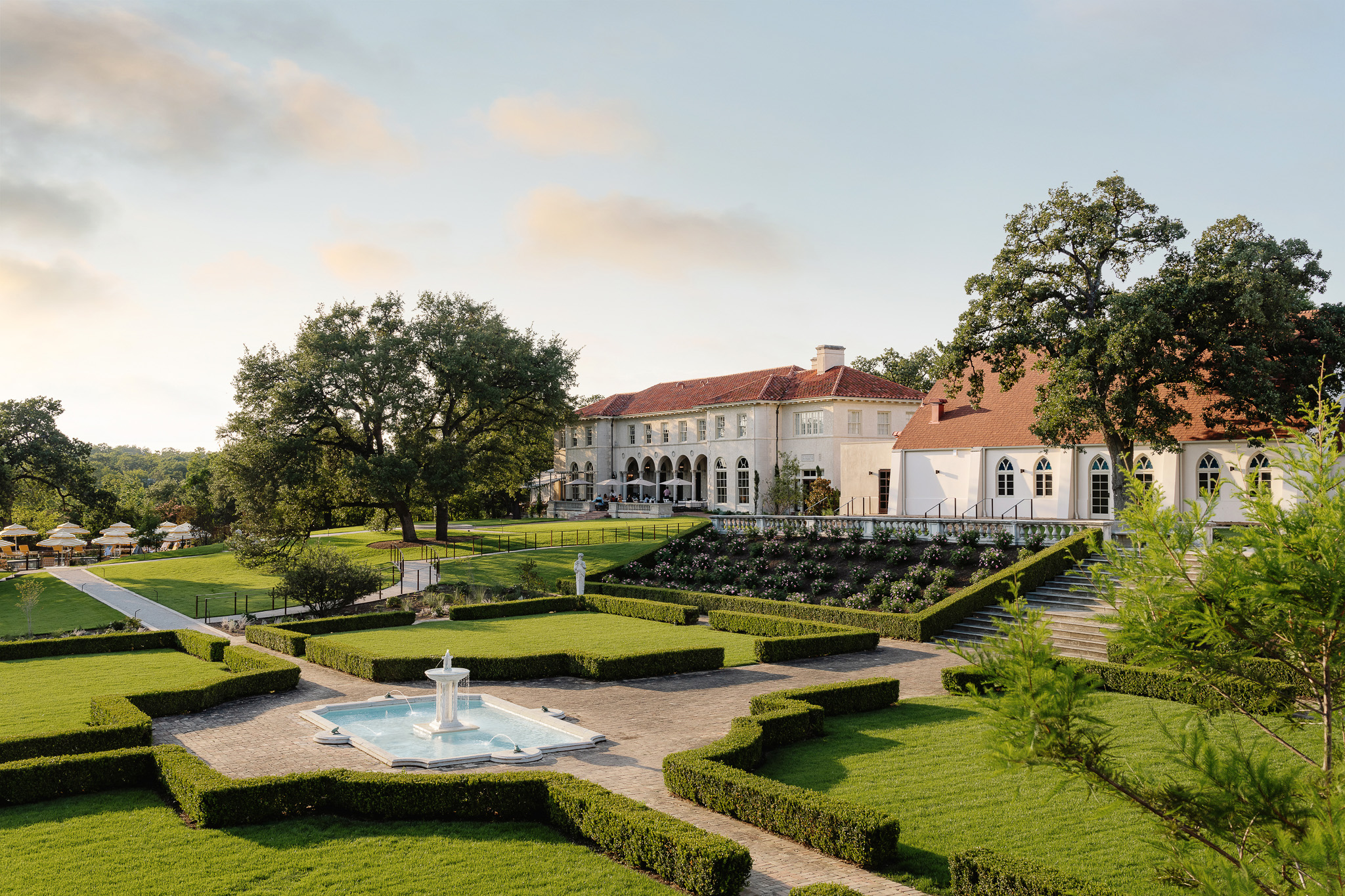 This shot of the Commodore Perry Estate features the manicured bushes, lush garden, Spanish tiled roof buildings and the overall scope of a gorgeous estate.
