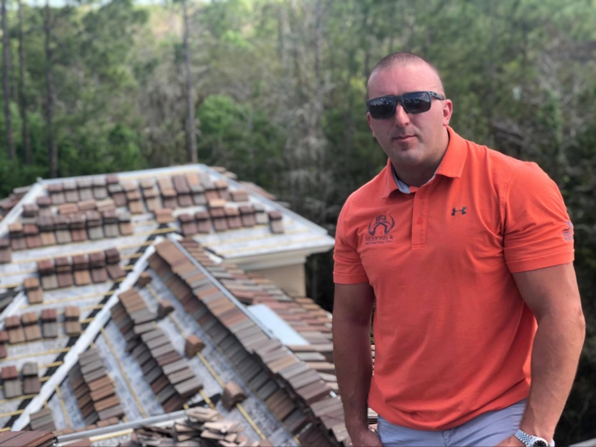 man standing on working roof