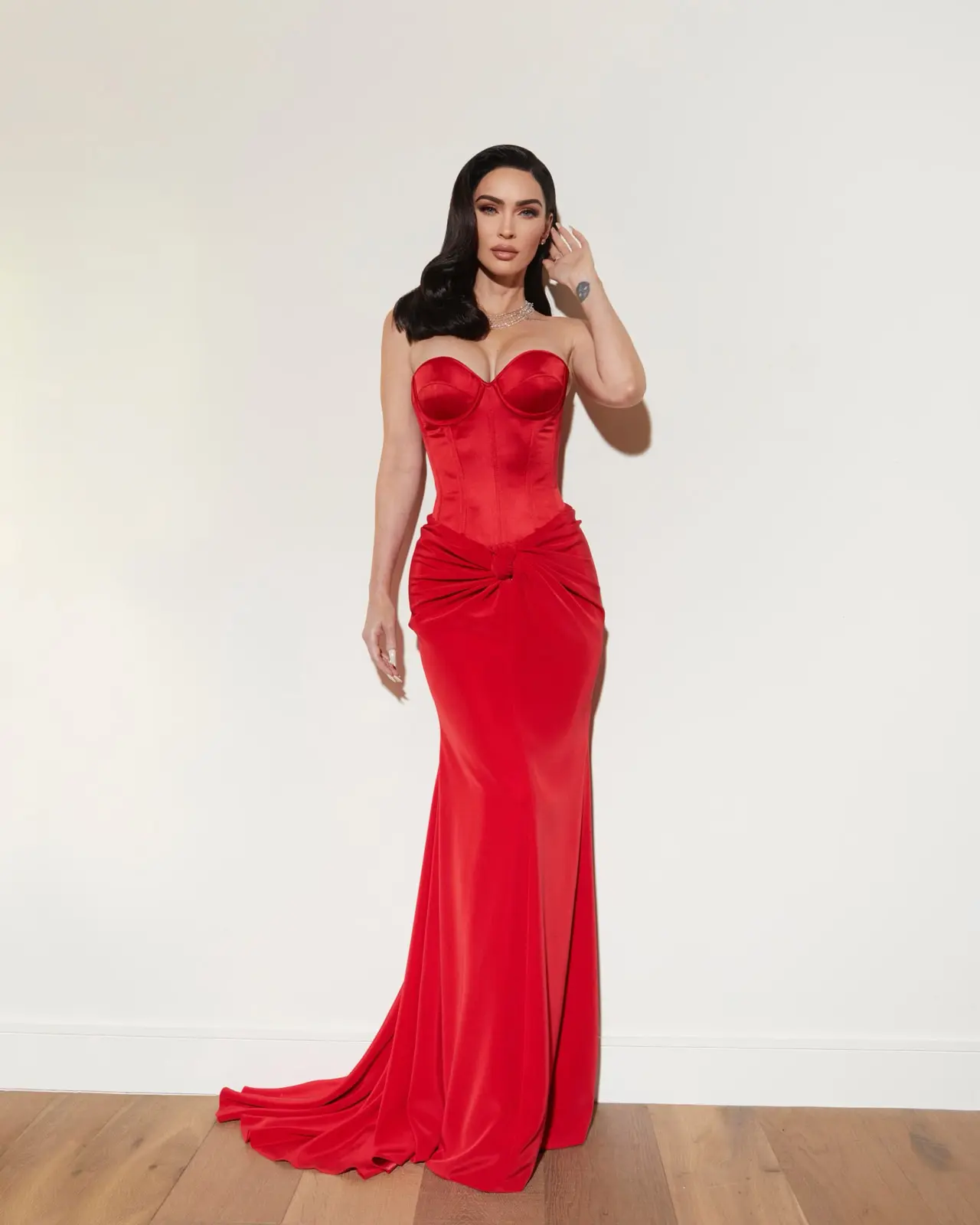 Striking full-body shot of a model in a bold red satin gown with sculpted corset, styled by Sepulveda Studios.