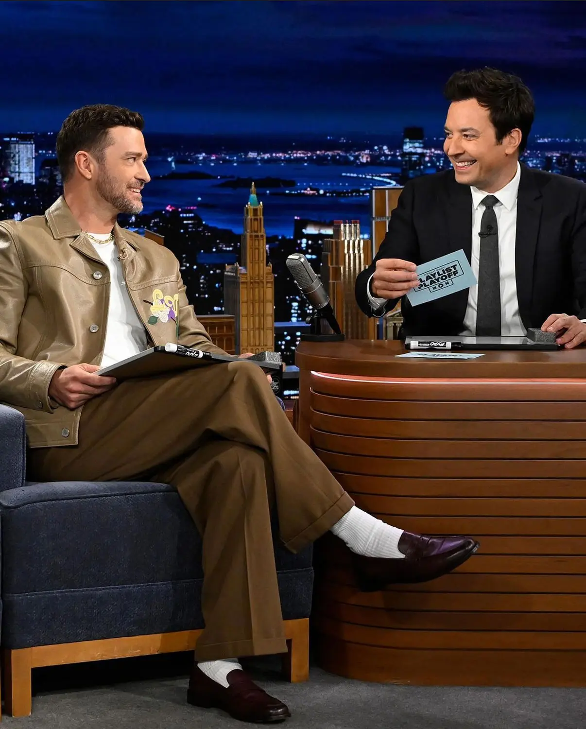 Justin Timberlake appears on The Tonight Show with Jimmy Fallon, styled in a tan leather jacket and wide-leg trousers. Photographed by Sepulveda Studio, capturing a polished celebrity moment with relaxed sophistication.