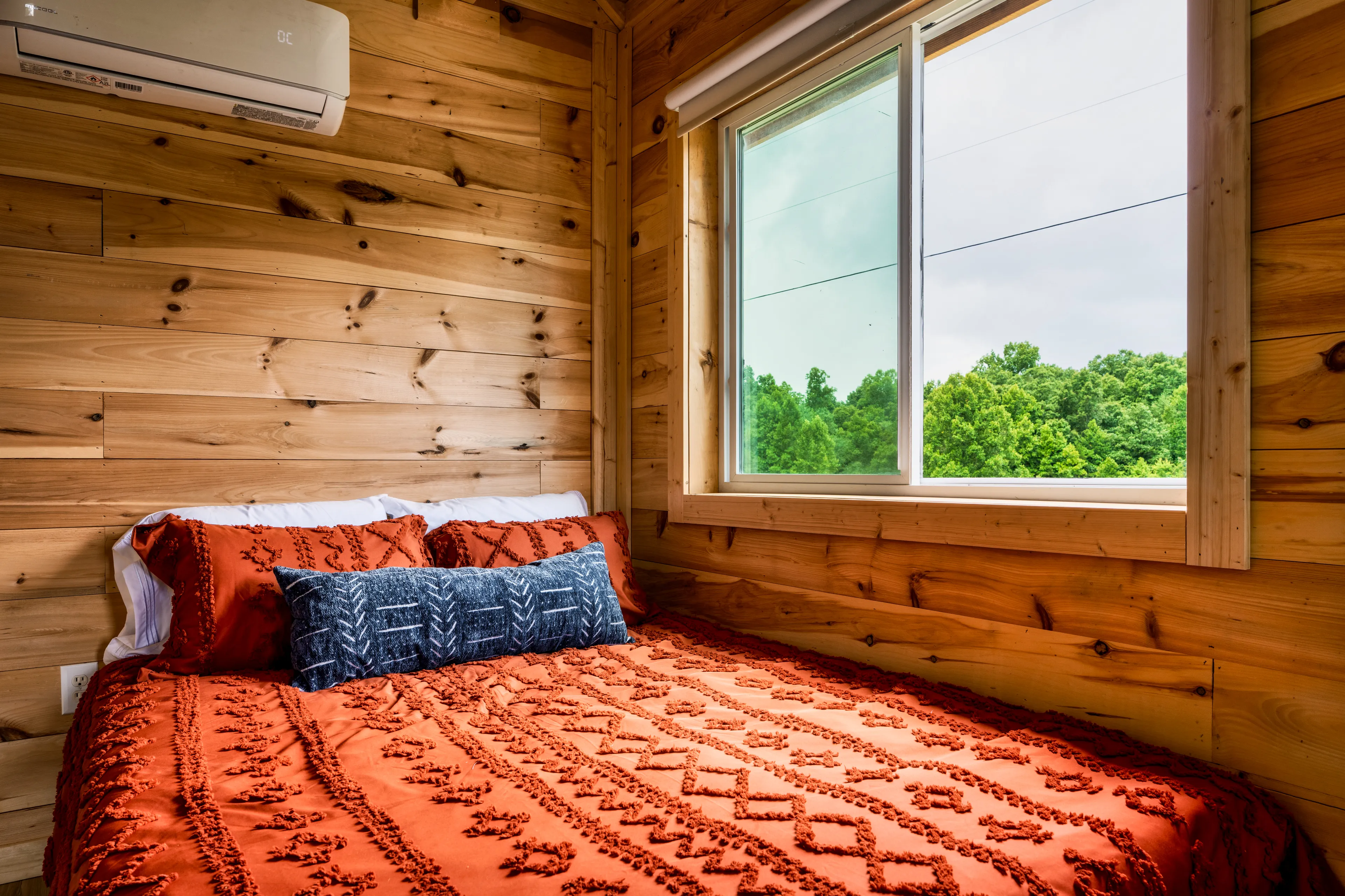 Loft bedroom with treetop views at Black Creek Treehouse