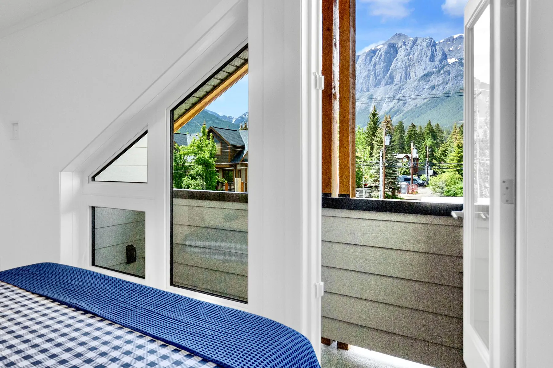 A bedroom in a Colliery Parc townhome in South Canmore looking out to the mountains