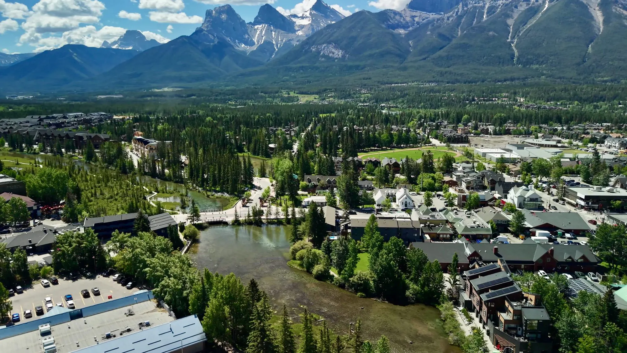 Canmore from the air in the Bow Valley, the Three Sisters behind the town