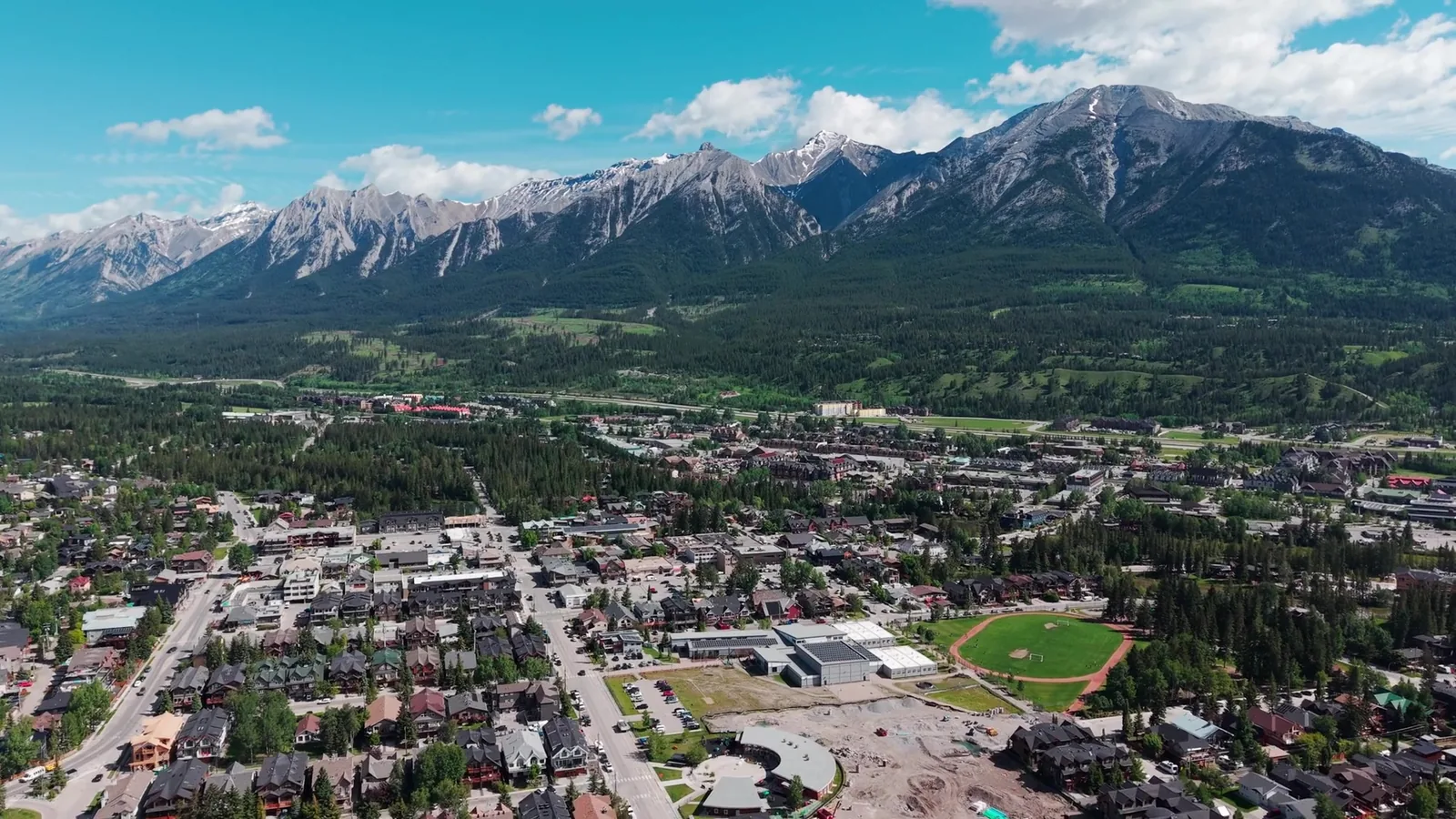 Canmore from the air in the Bow Valley, the Three Sisters behind the town