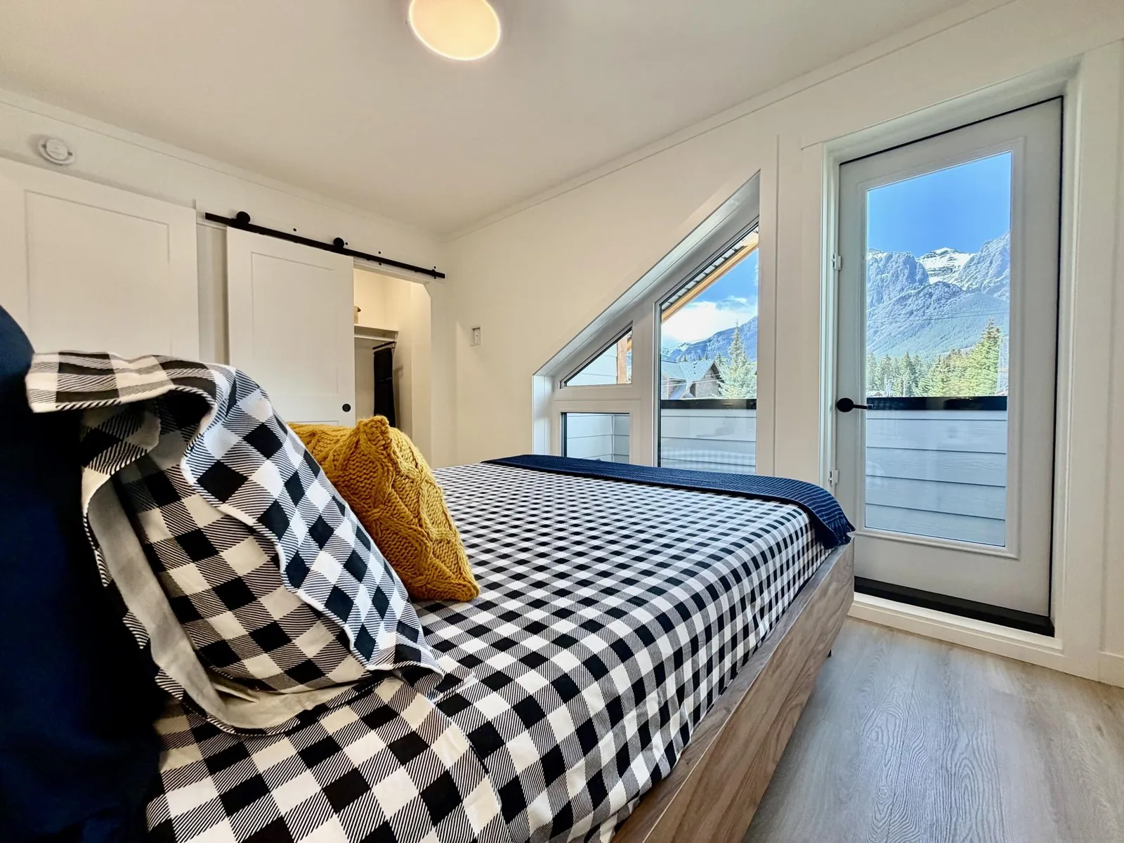 A bedroom at Colliery Parc in South Canmore with the mountains through the window
