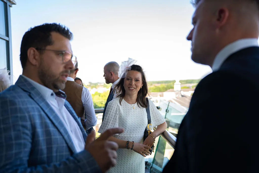 A group of people talking and smiling at the Blue Bricks Horses and Houses property networking event