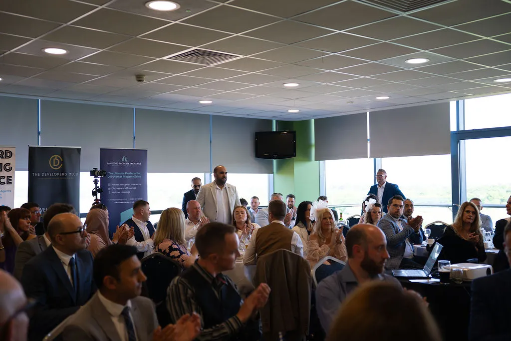A large group of mainly seated people listening to someone speaking at the Blue Bricks Horses and Houses property networking event