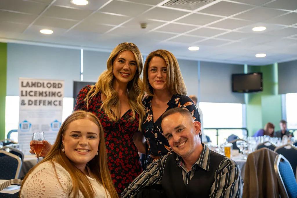 A group of people smiling at a property networking event