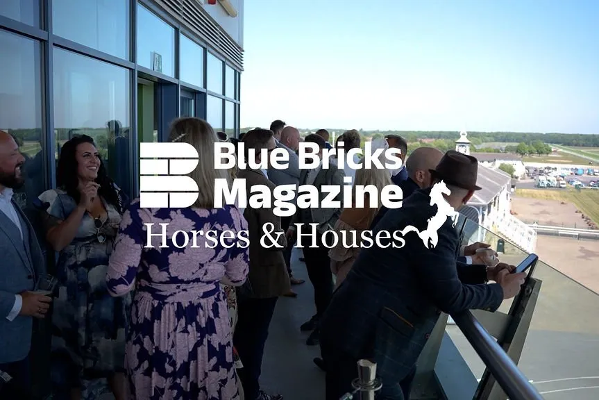 People dressed smartly on the balcony overlooking Doncaster Racecourse at the Blue Bricks Horses and Houses event