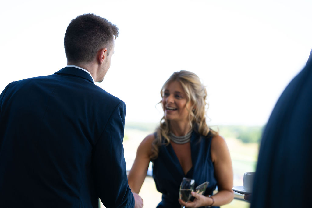 A man and a woman meeting and shaking hands at the Blue Bricks Horses and Houses property networking event