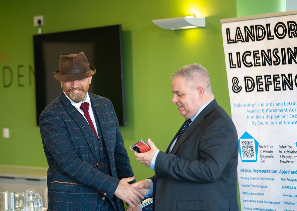 2 men shaking hands at the Blue Bricks Horses and Houses property networking event