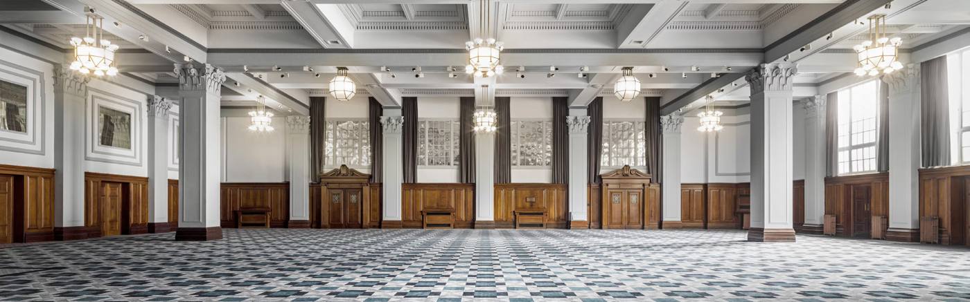 The conference room at Kimpton Clocktower Hotel, with a chequered floor, panelled walls and chandeliers