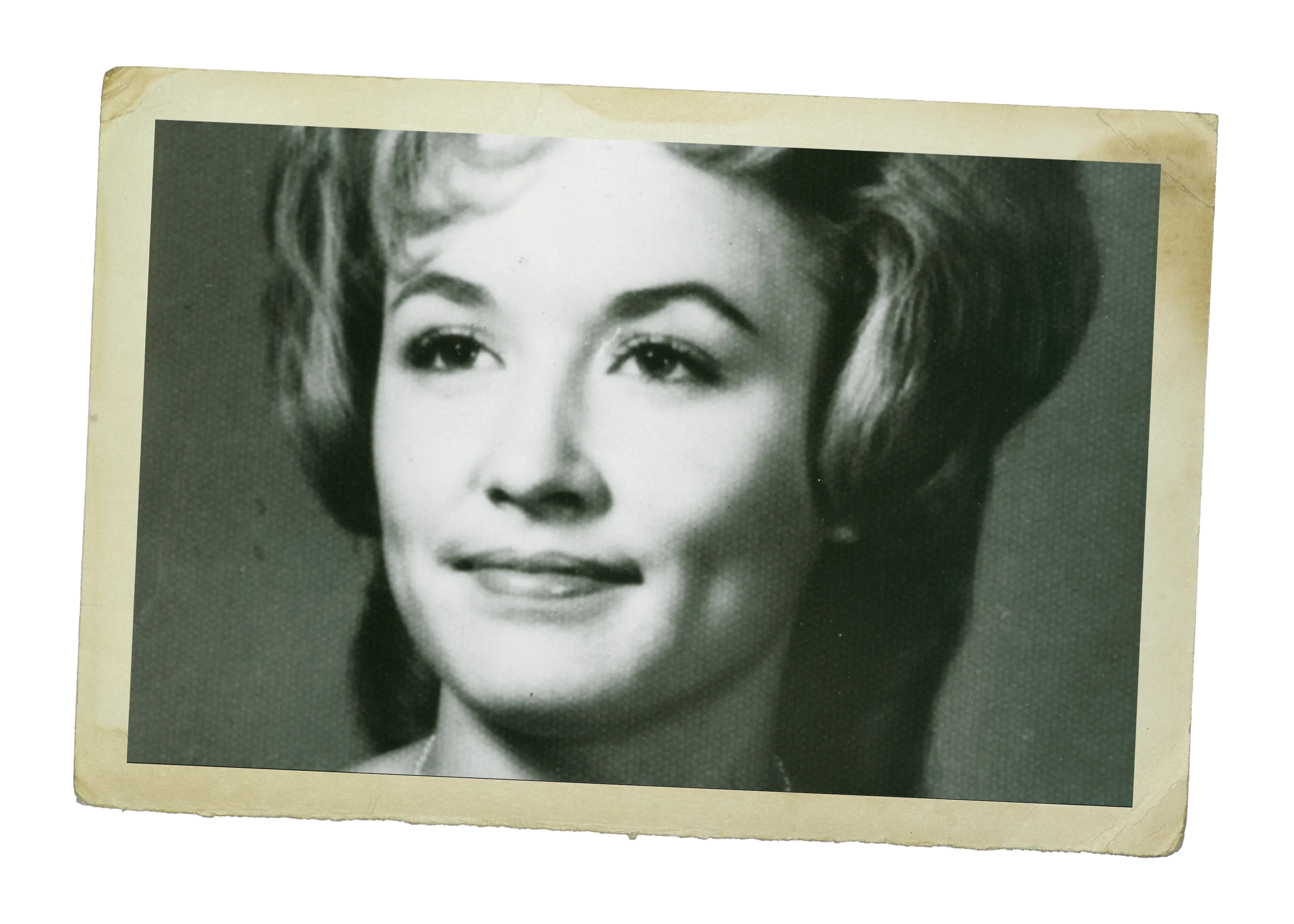 A vintage black-and-white portrait of a young Dolly Parton, wearing a classic hairstyle and smiling softly.