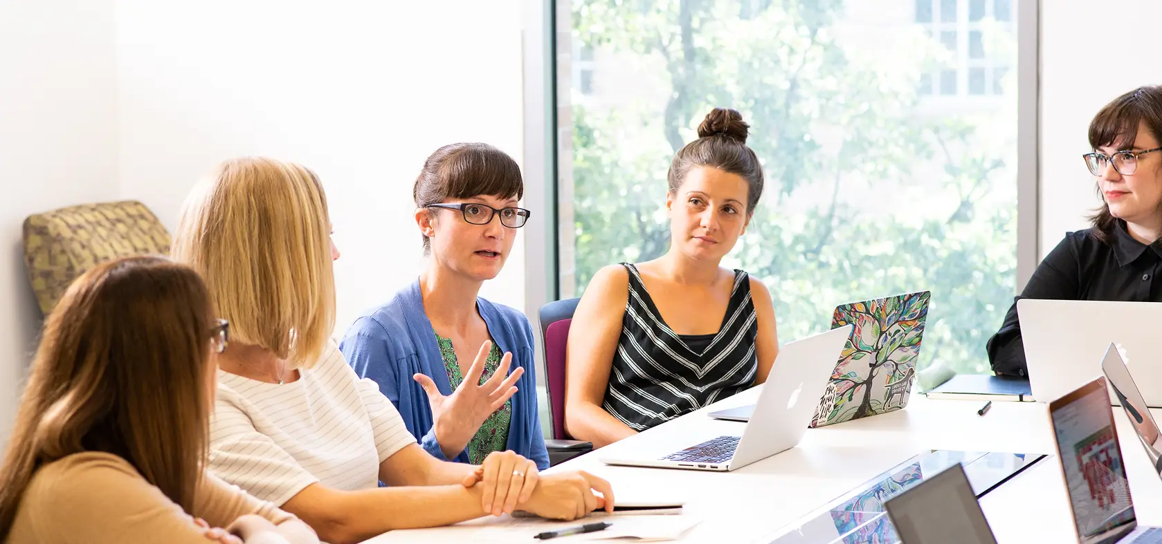 Preston Lab team sitting at a conference table having a discussion.