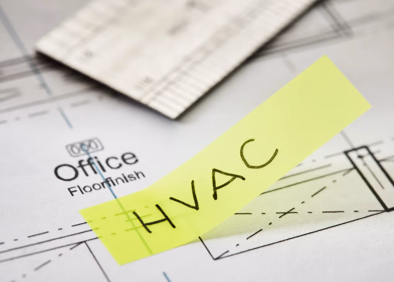 HVAC marked on a building blueprint with a sticky note to show project planning.