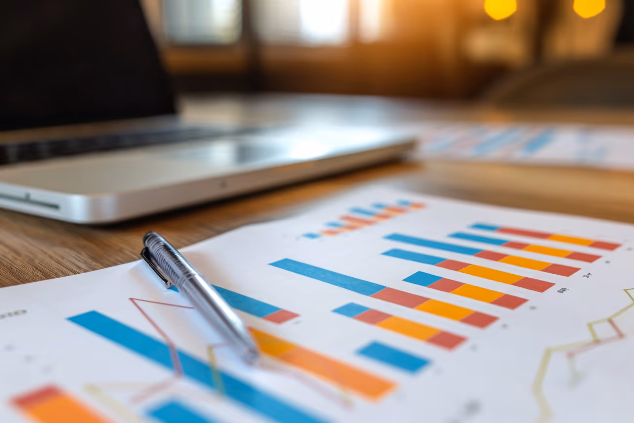 Laptop and printed financial charts used to review HVAC company valuation readiness.