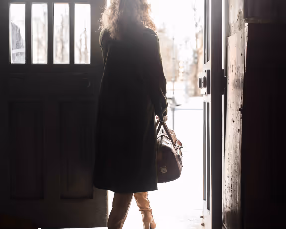 HVAC business owner walking out with a work bag after stabilizing operations and finances.