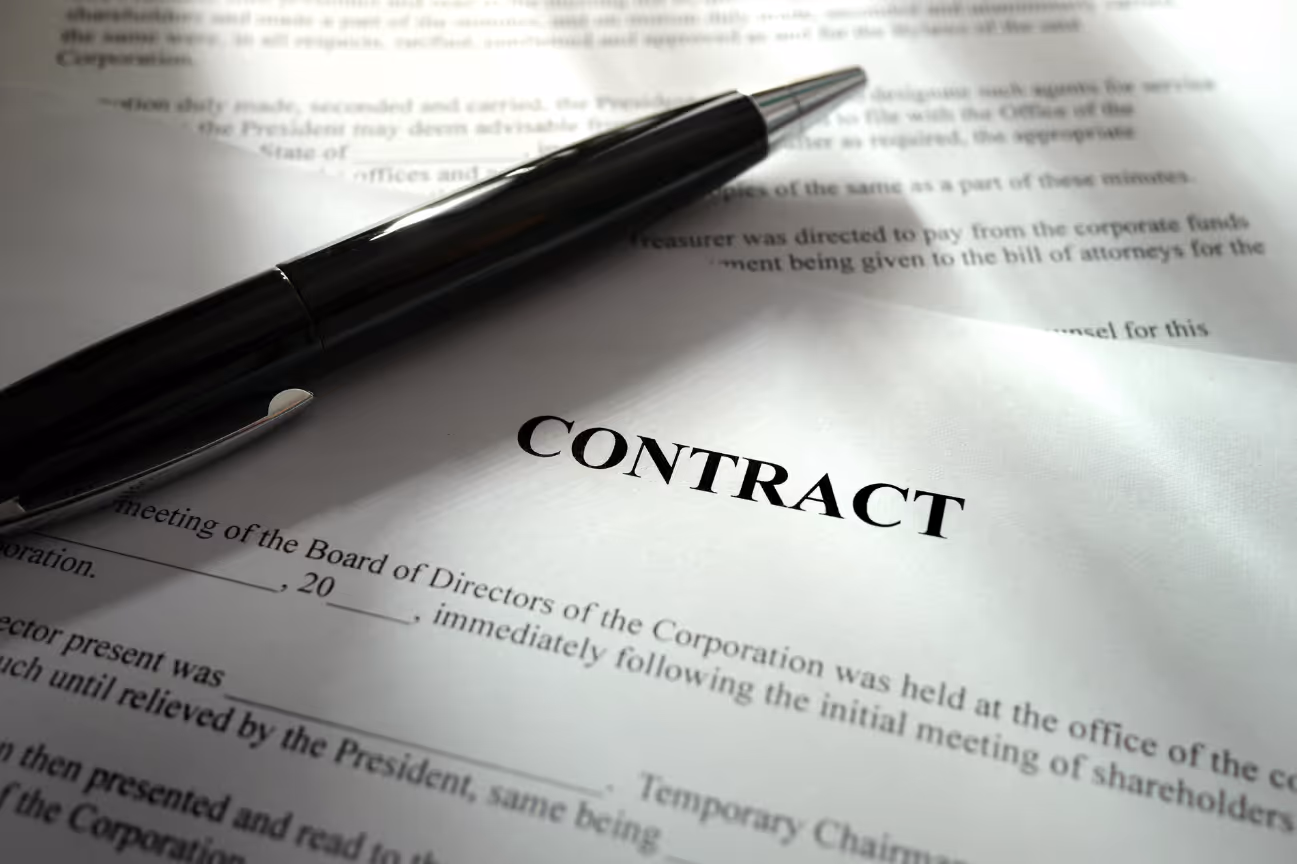 Close-up of contract paperwork with a pen, symbolizing valuation work and vendor renegotiation planning.