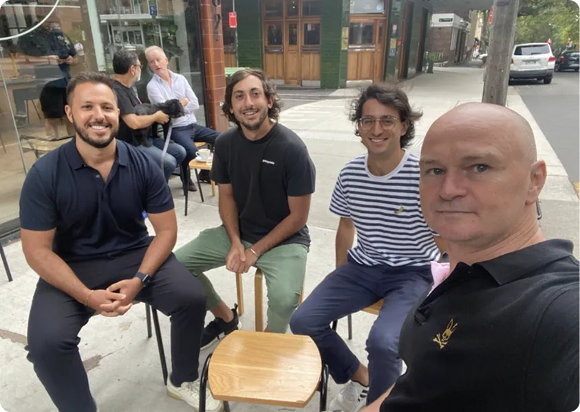 4 members of the company sitting on chairs