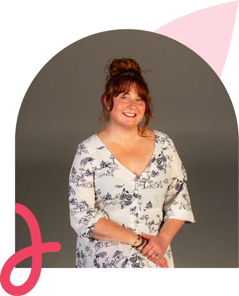 Mother and father holding daughter in front of house