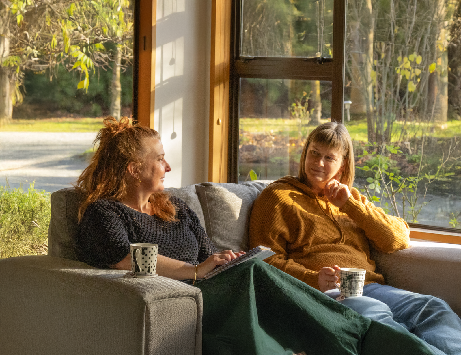 Two people talking on a couch