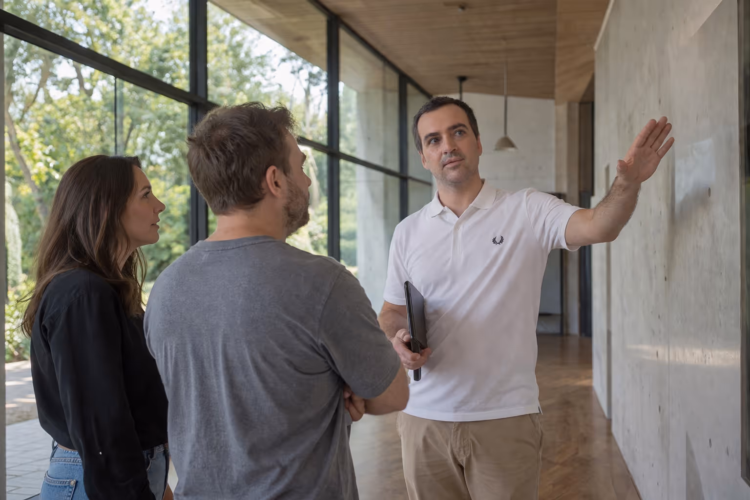 Nicholas Marriott consulting with clients on-site. The image highlights his expertise in architectural acoustics, sustainable design, and project leadership within modern, high-end interiors.