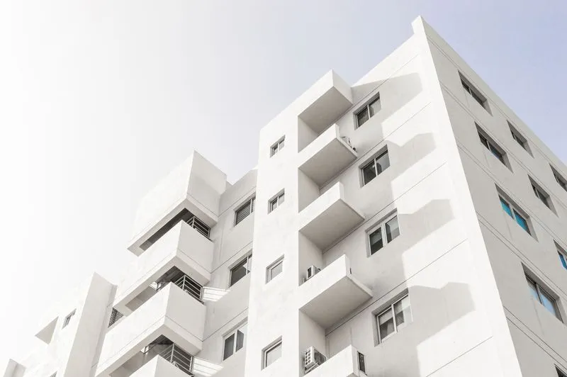 low angle shot facade white modern building blue clear sky huge