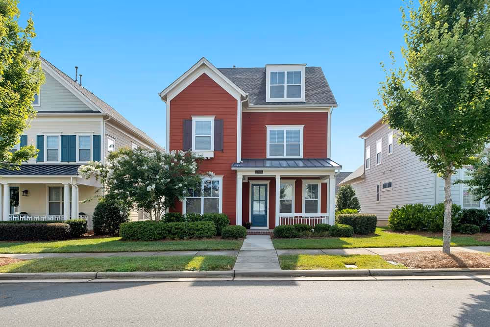 red house with neighbor houses