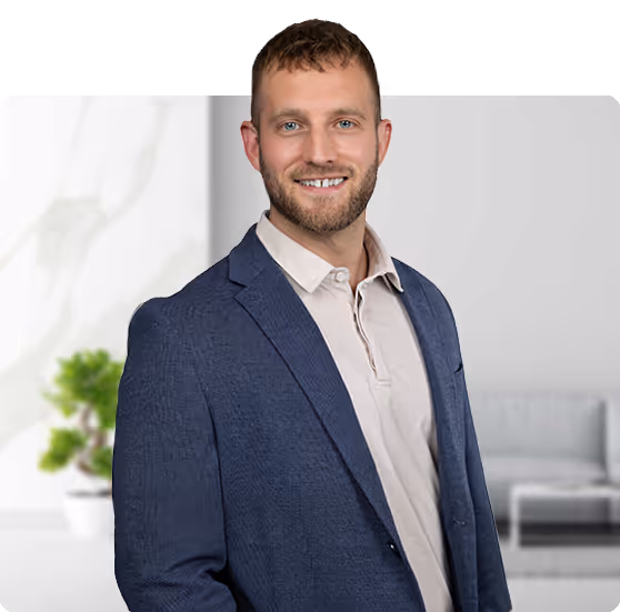 Smiling professional in blue blazer standing in bright office setting
