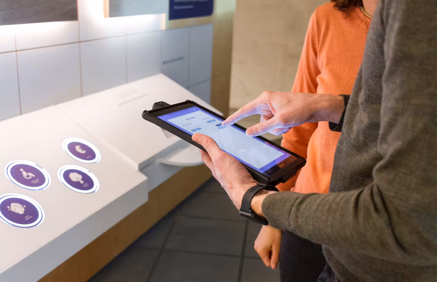 A man and a woman use a tablet to make interior design choices at Bam Homestudios