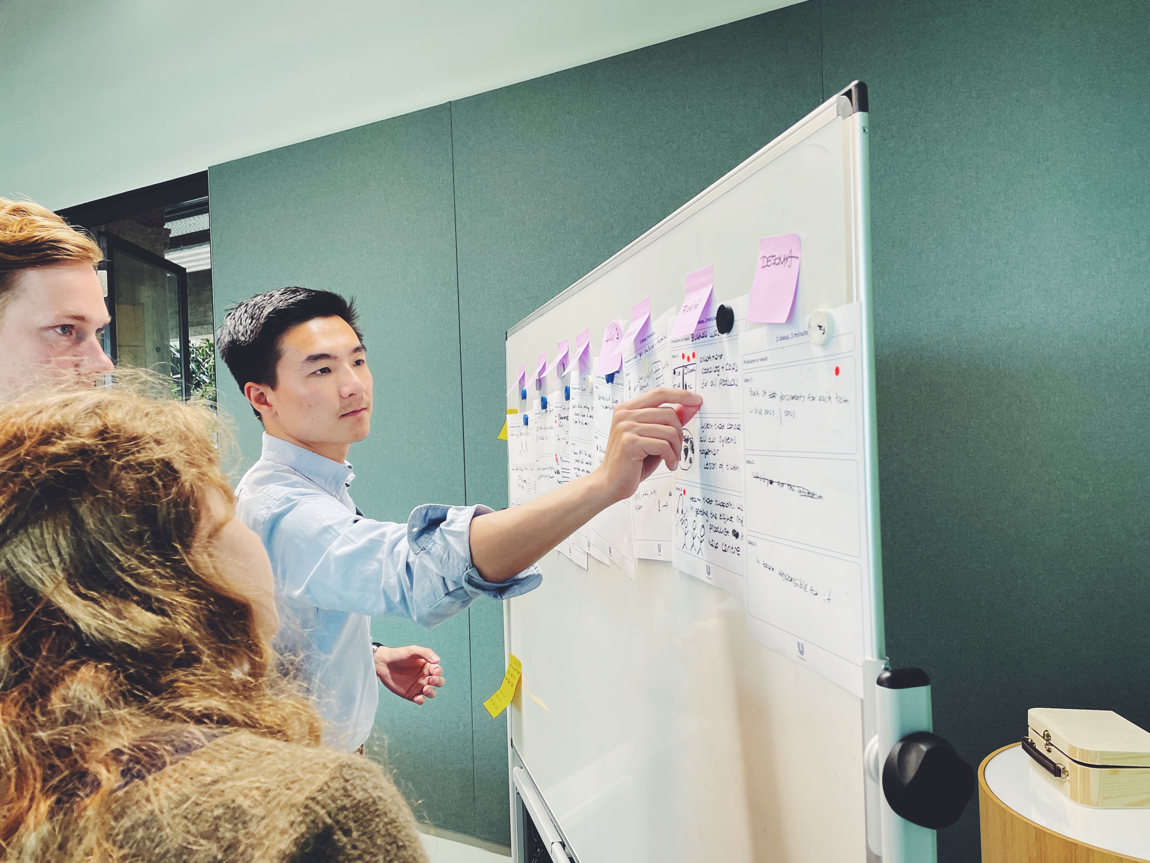 A man and a woman use a tablet to make interior design choices at Bam Homestudios