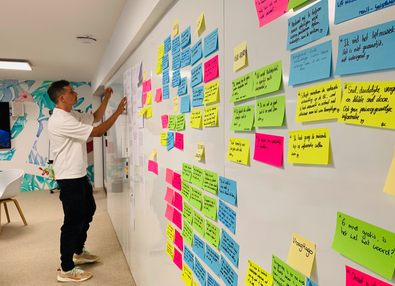 A man and a woman use a tablet to make interior design choices at Bam Homestudios