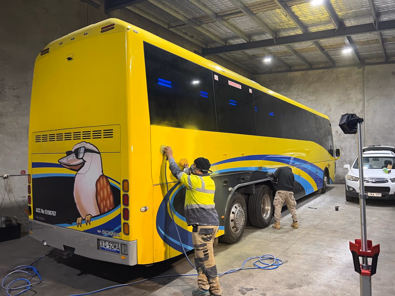 a man painting a bus