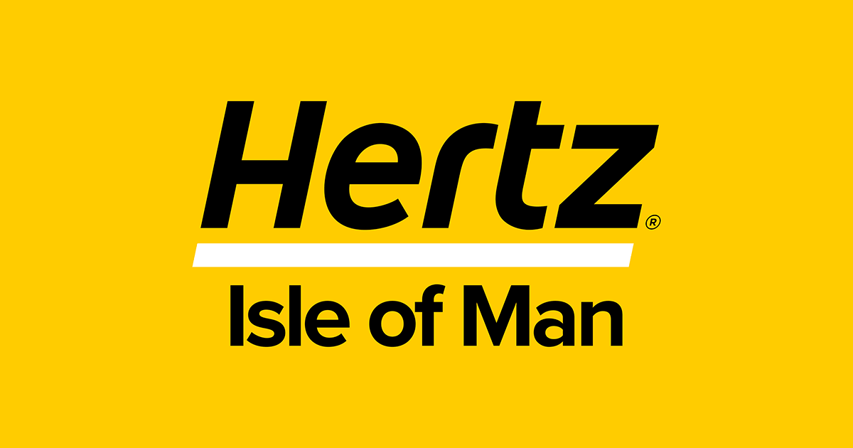 Woman in yellow shirt holding a hat, standing barefoot on a dry grassy hill, looking at a sunset over distant mountains and valley. for Hertz isle of man car hire