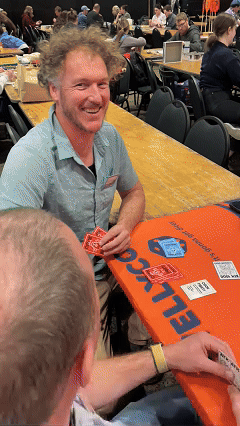 A male smiling at the camera playing CockFight! at Wellycon