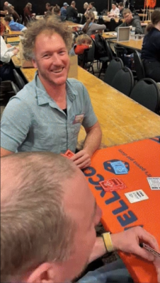 A male smiling at the camera playing CockFight! at Wellycon