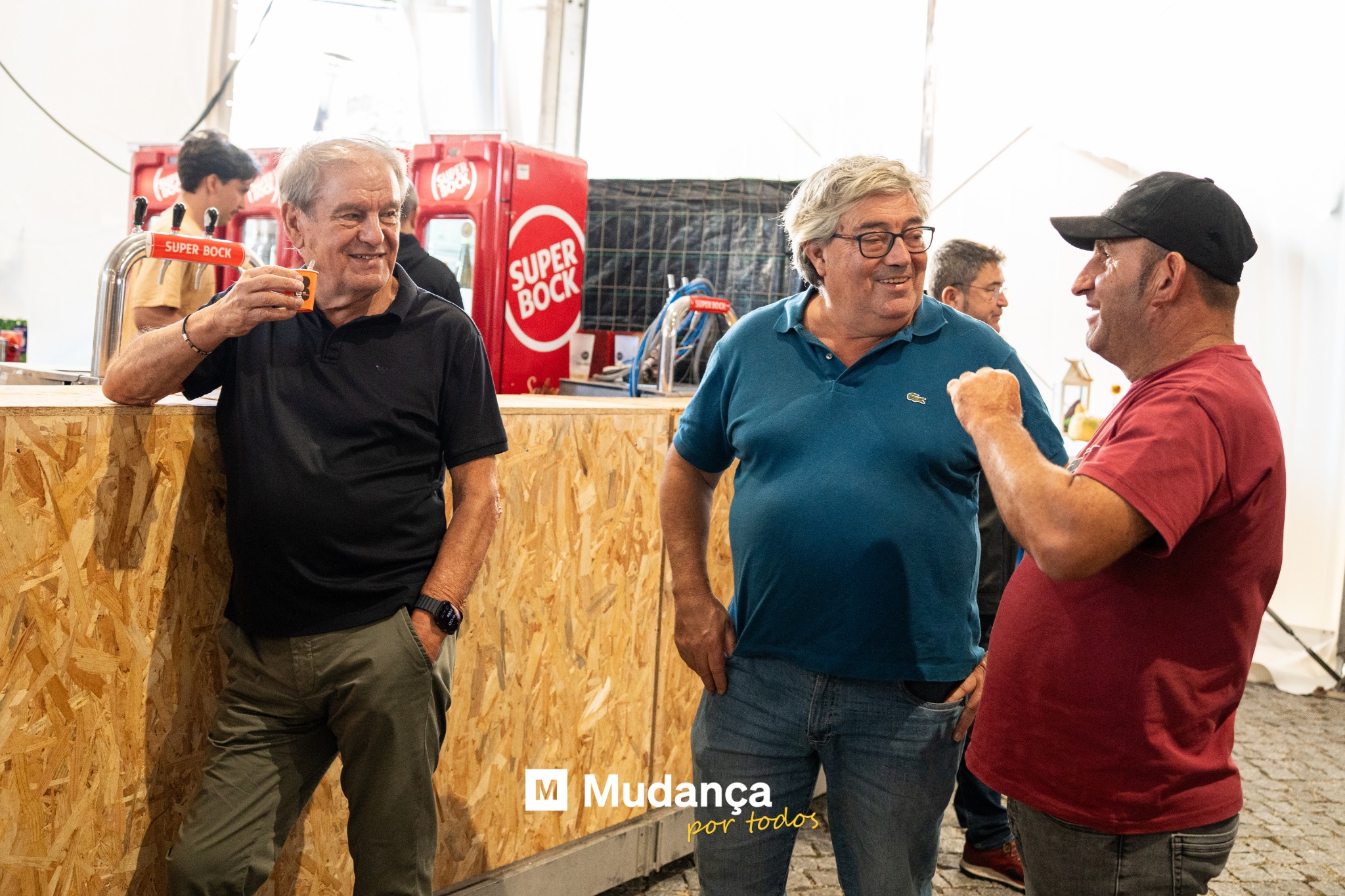 Pode ser uma imagem de 3 pessoas, madeireira e a texto que diz "SUPER BOCK SUPER SUPER BOCK 한국 M Mudança por portodos todos"