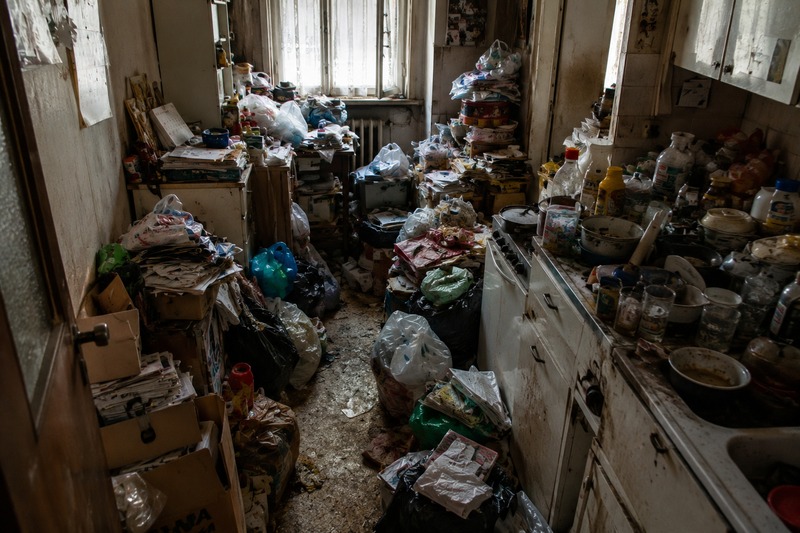 Cuisine insalubre envahie de déchets dans un logement touché par le syndrome de Diogène