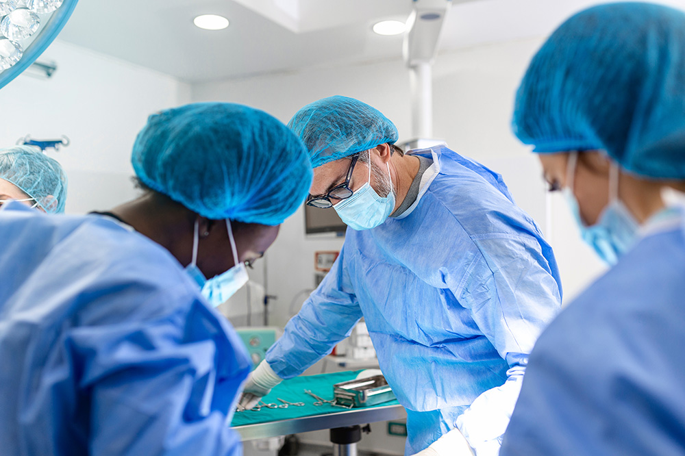 A surgery team operating on a patient in an operating theatre.