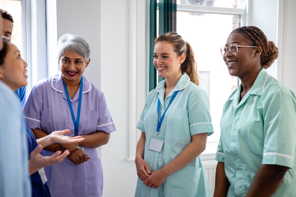 Three nurses talking to medics