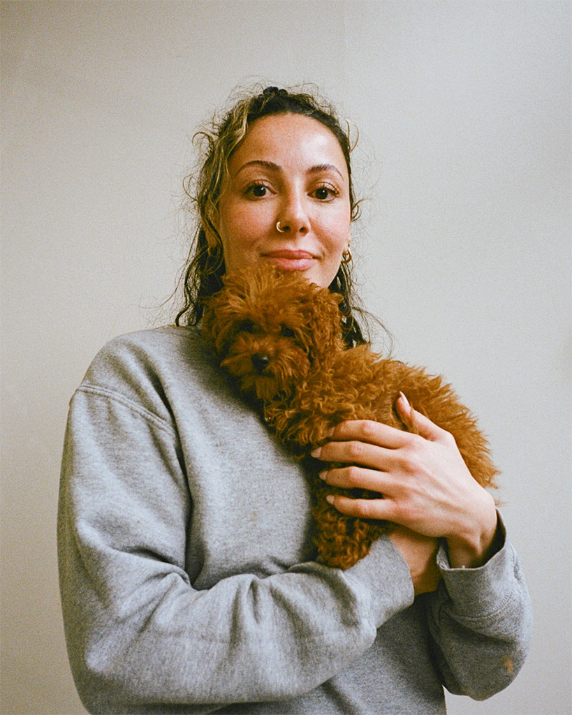 Hackney Barkers groomer holding a cockapoo puppy