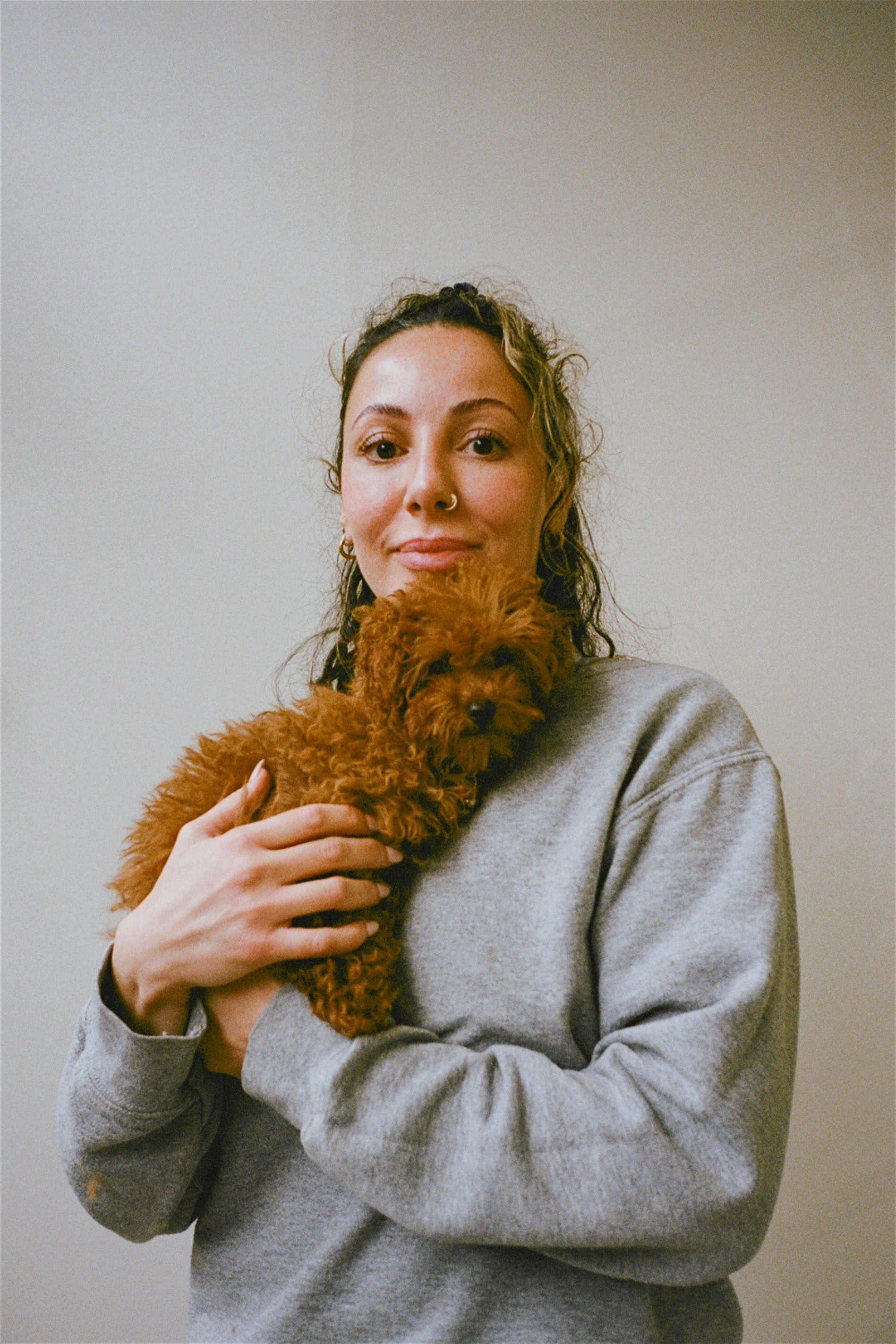 Jade holding a Maltipoo puppy at Hackney Barkers dog grooming salon in Hackney