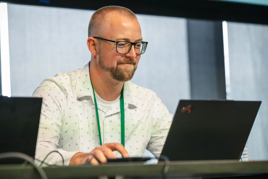 A man working on a laptop.